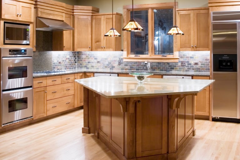 Luxury kitchen featuring custom cabinetry with granite countertops and modern appliances