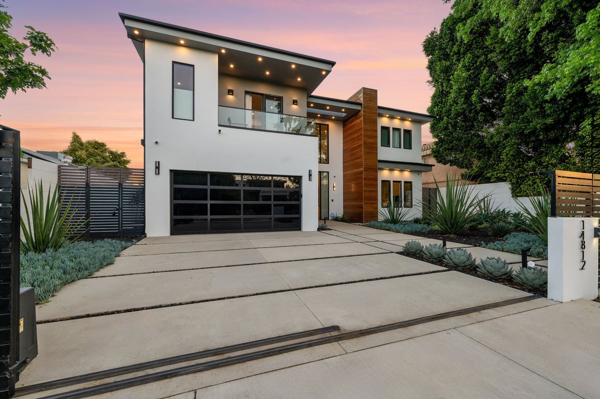 Modern luxury home at twilight with pool and architectural lines