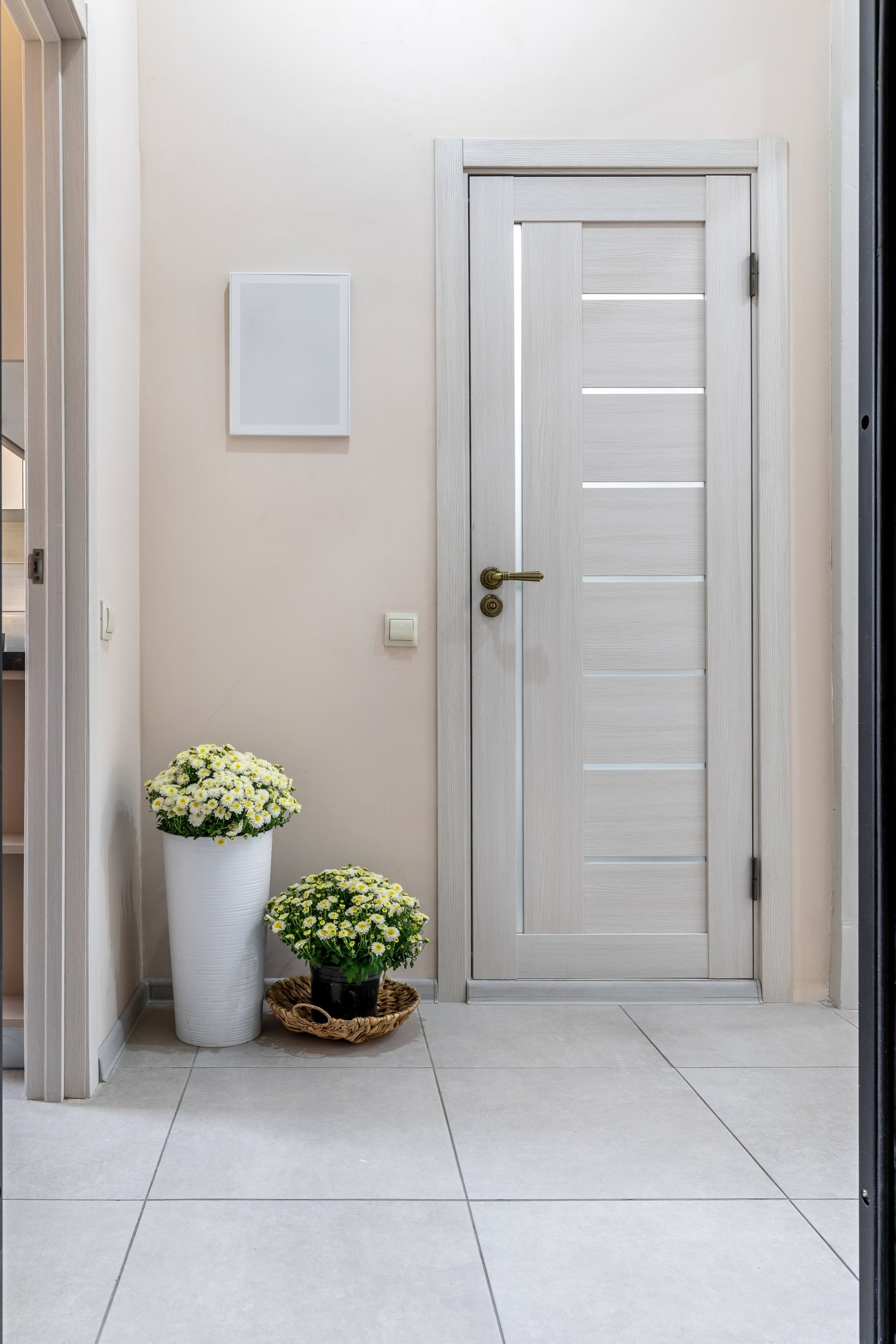 Bright modern entryway with custom cabinet design