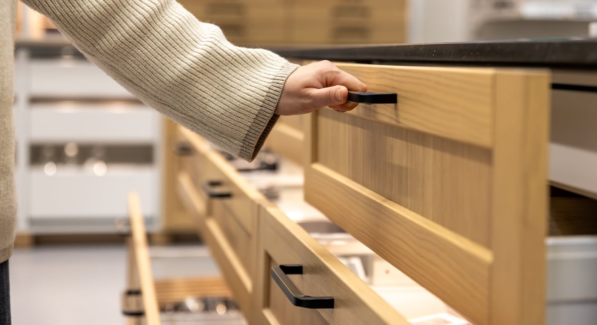 Warm wood custom cabinets featuring smooth drawers with premium black hardware